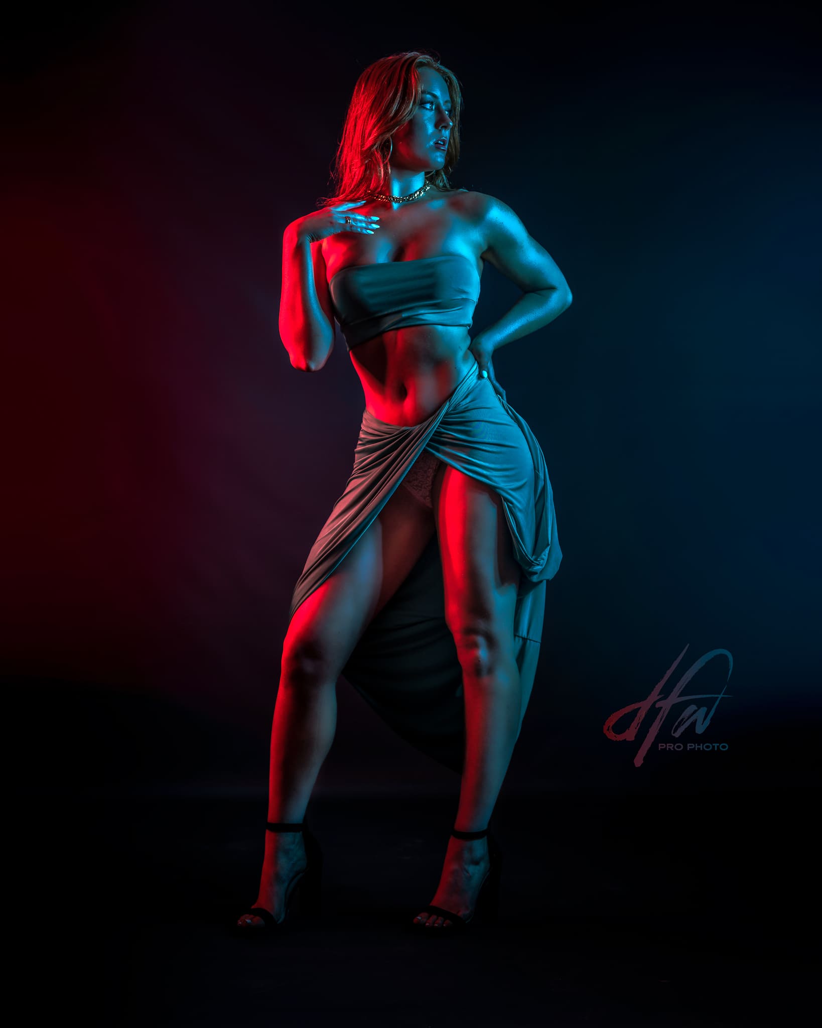 Girl posing with dramatic red and blue lighting.