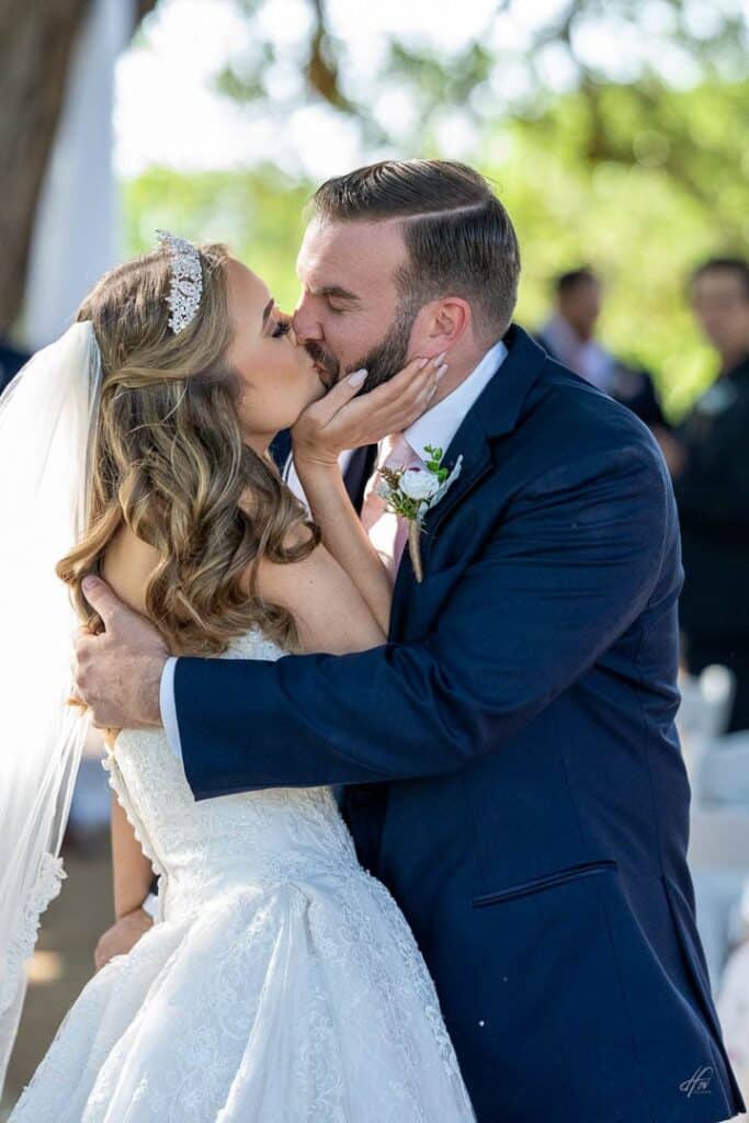 Newlyweds kissing after ceremony.